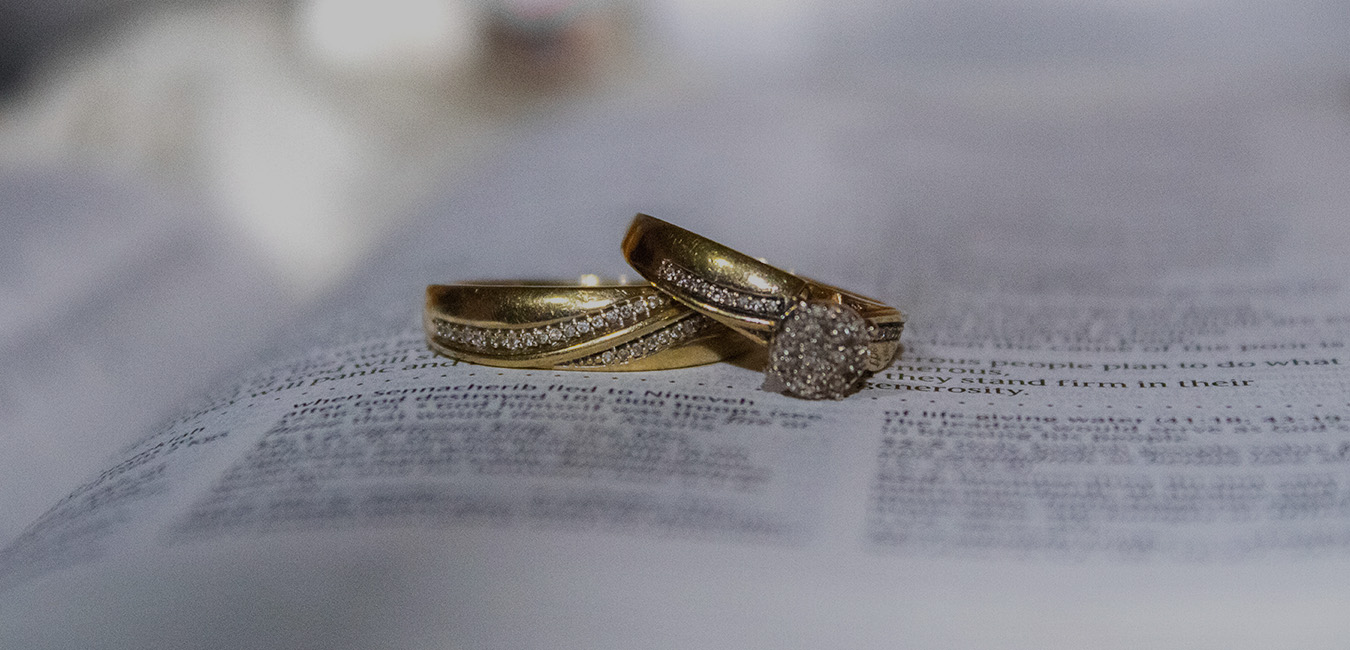 Wedding rings on a Bible symbolizing a marriage based green card.