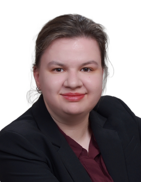 Our Team A person with light skin, brown hair tied back, wearing a black blazer and maroon shirt, smiles at the camera—reflecting the professional image of Chicago EB-3 visa lawyer services against a plain white background.